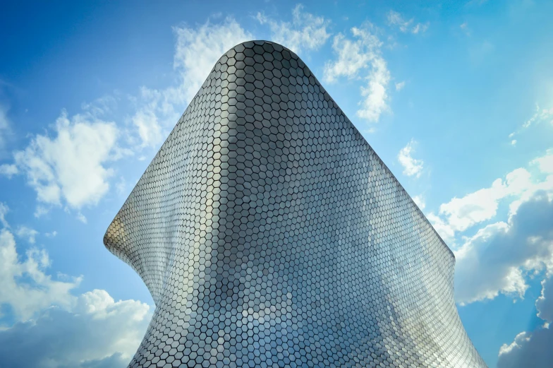 a building is shown against a blue sky with clouds