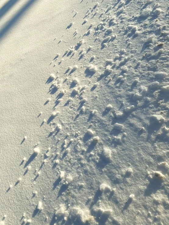 a person is snowboarding on top of some snow