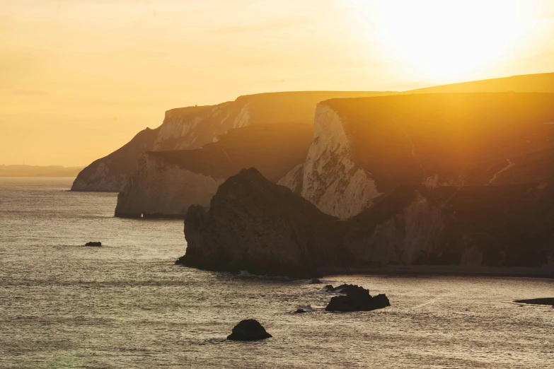 a boat is traveling in the water near some cliffs