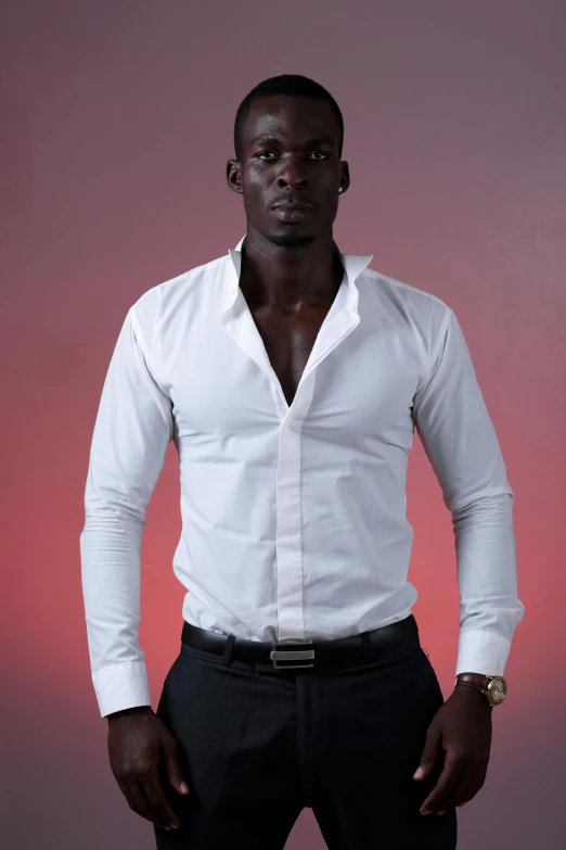 a black man posing in a white shirt and a tie