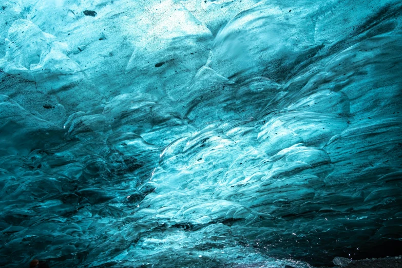 the inside of a deep underwater hole shows a blue sea and blue sky