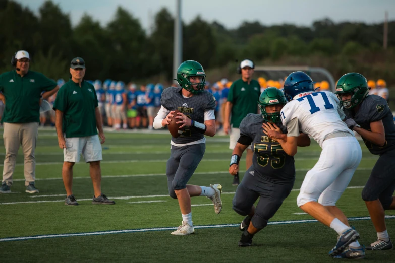 a football game with a player holding the ball