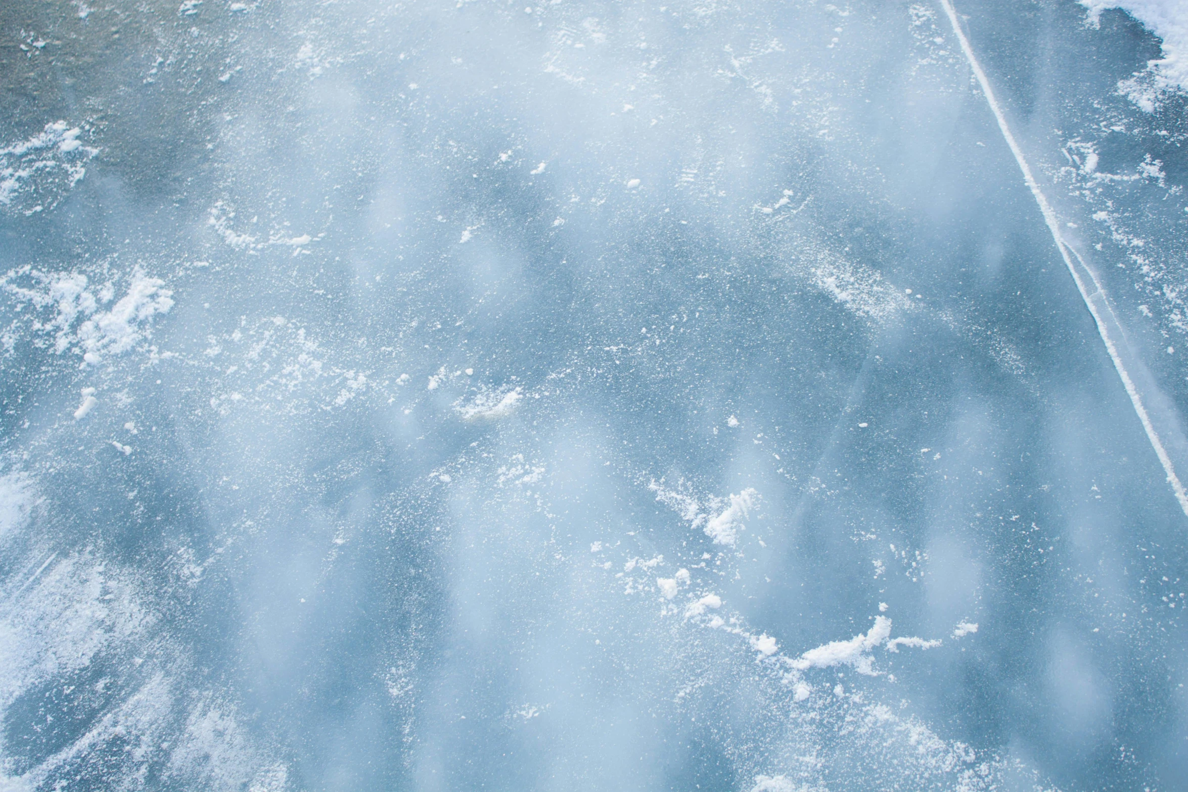 a jet flying through the air above snow covered ground