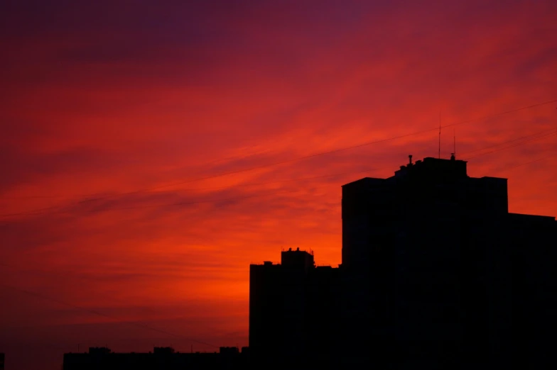 a bird flying in the sky during sunset or sunrise