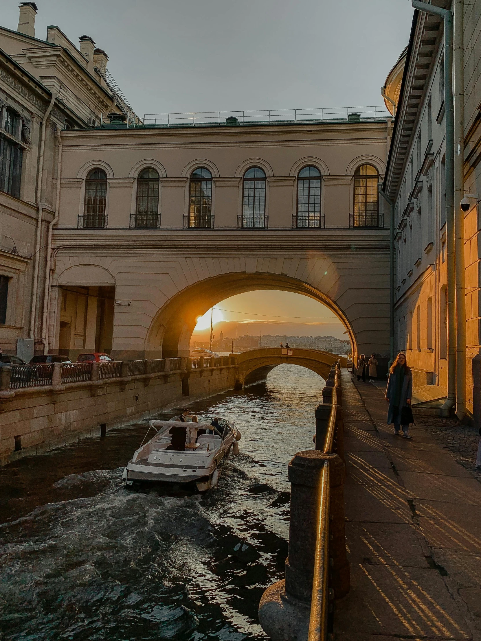 a person on a long bike going under an arch bridge