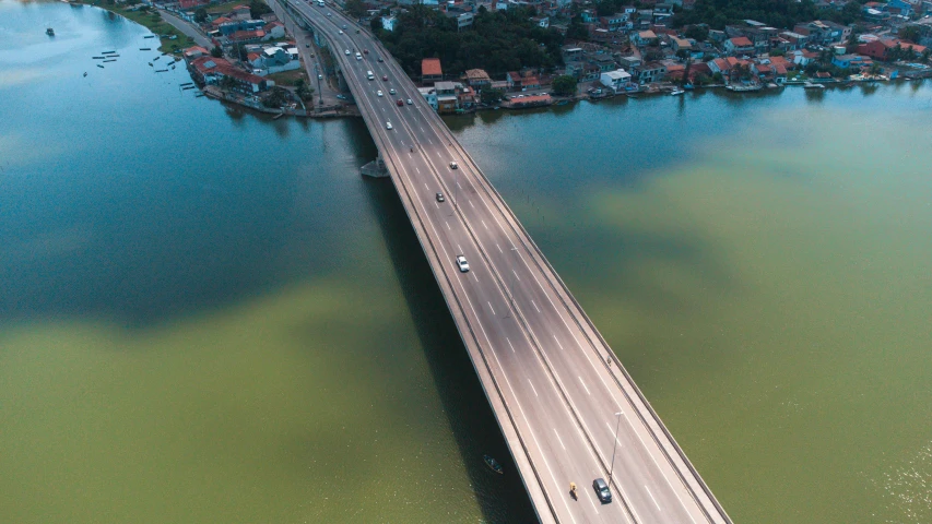 a long, white road bridge over looking a river