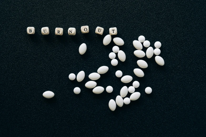 a table has pills and some wooden blocks spelling out bunnuut