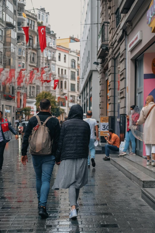 a couple of people that are walking down a road