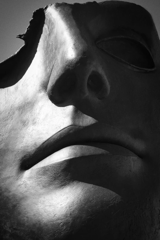 a sculpture in the shadow of a man's head with a mask on
