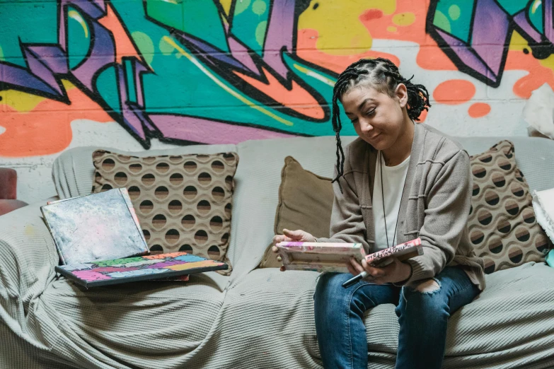 a person sitting on a couch with a laptop