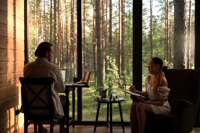 a couple of women sitting in front of a window