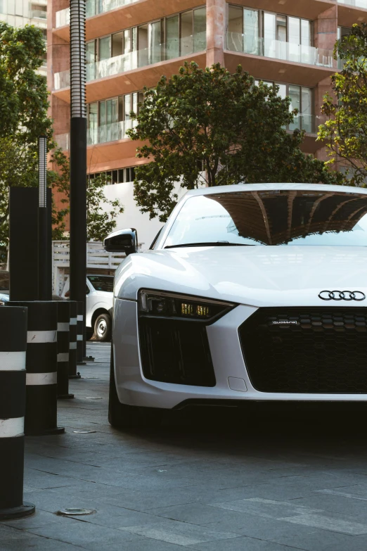 an audi sports car parked in front of a building