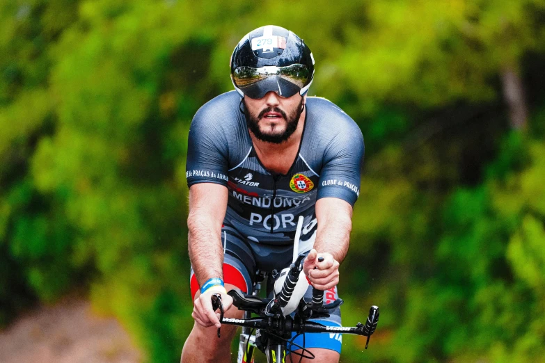 a man riding on top of a bike through the woods