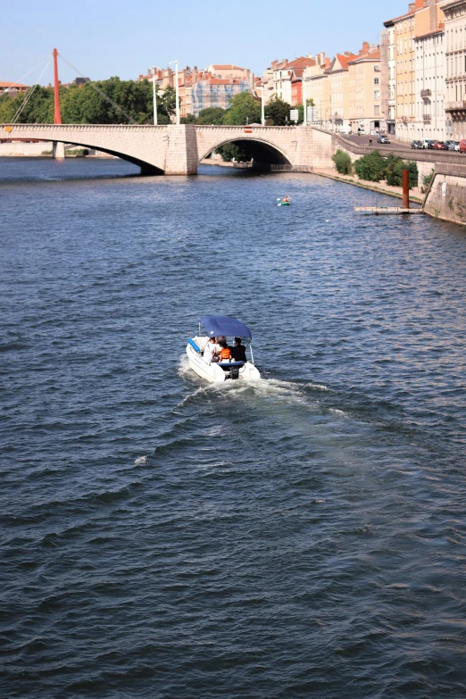 the white boat is in the middle of the water