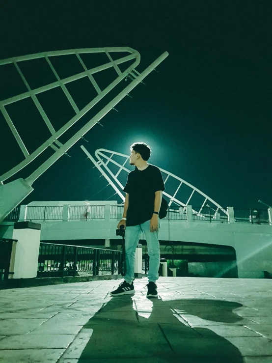 a person is standing on the walkway in front of a large white structure