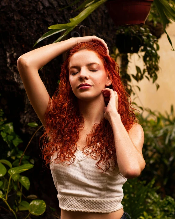 a girl with red hair is posing for a picture