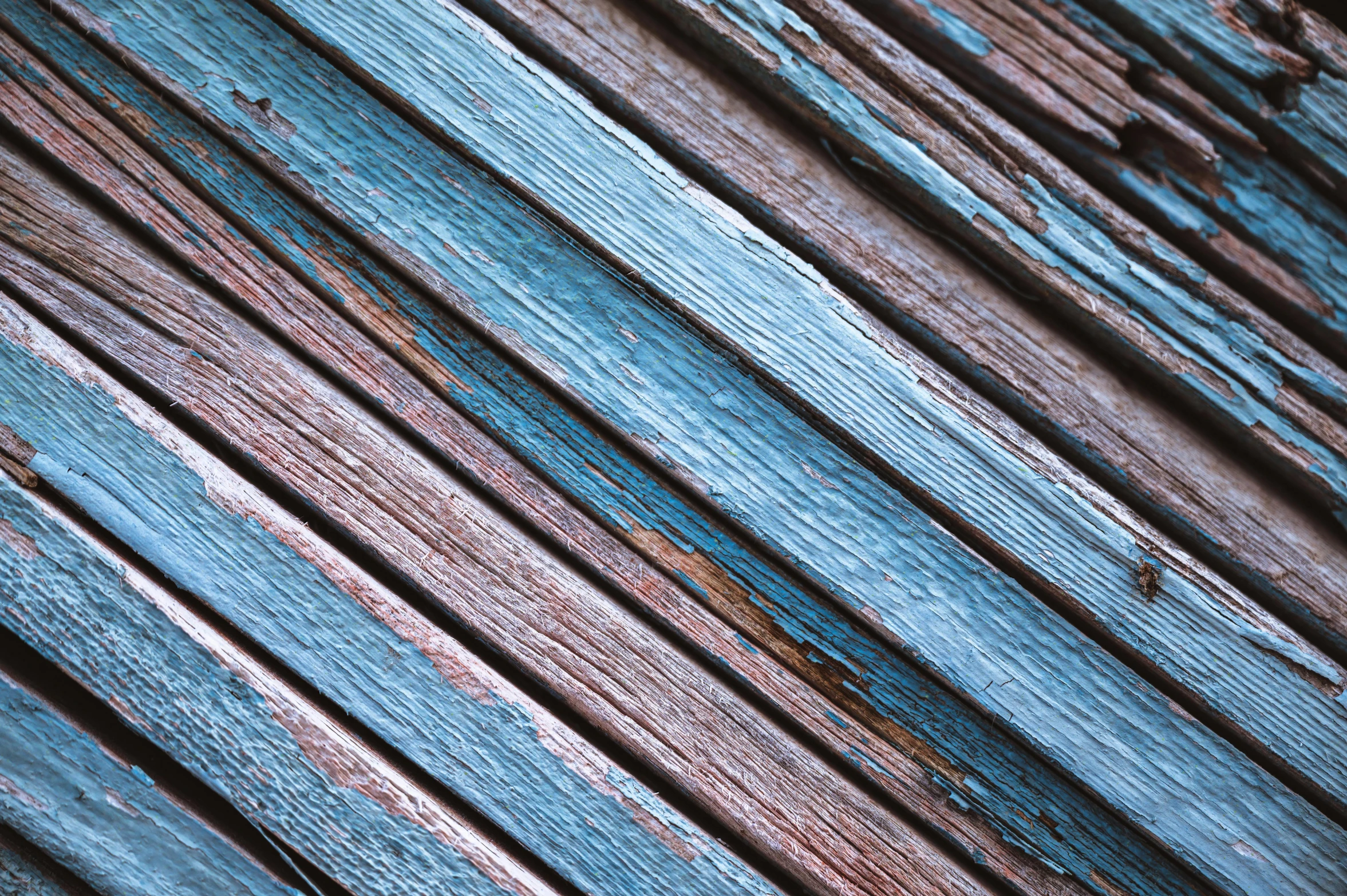 old, worn and painted wood is textured in blue