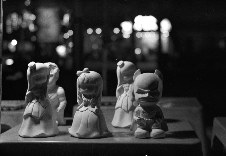 a set of three little dolls are sitting on a table