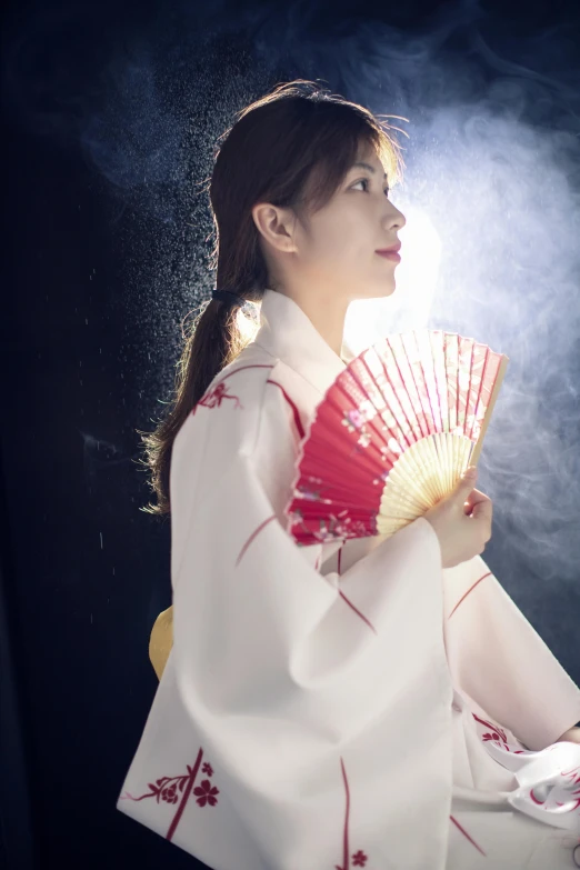 the woman is holding a fan in her hand