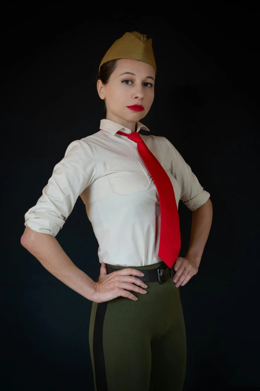 woman wearing uniform with red necktie and green pants