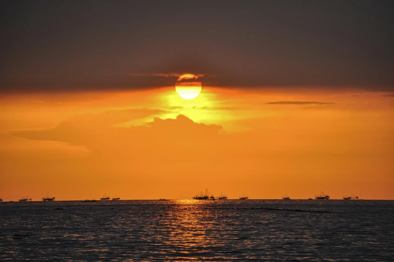 a po taken at sunset of a boat out on the ocean