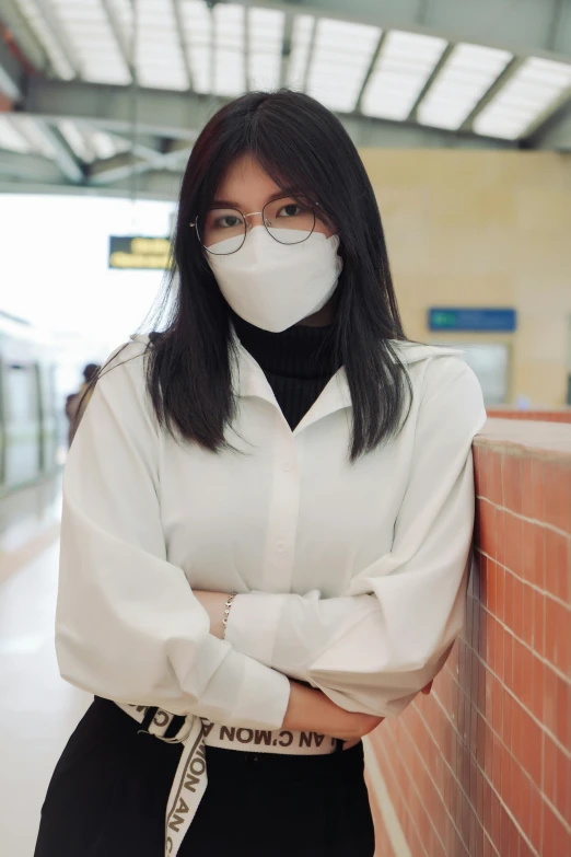 the woman is wearing glasses and a mask on her face