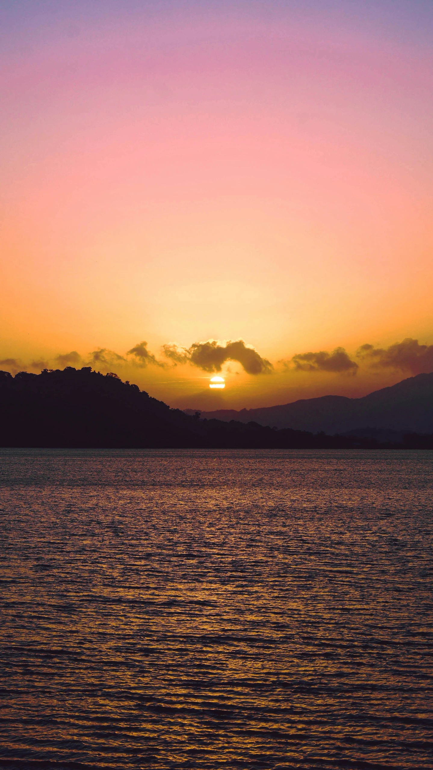 a very bright sunset over a body of water