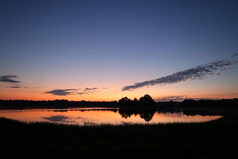 a beautiful sunset with the sun setting over the water