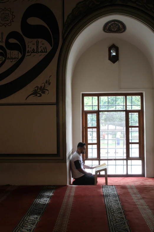 a man sitting on the floor of a room