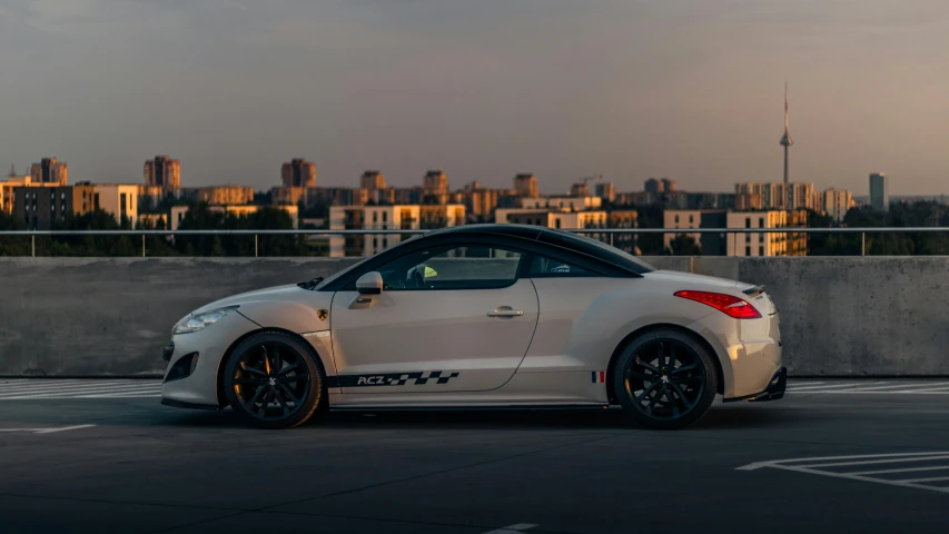 a white sports car parked in the parking lot