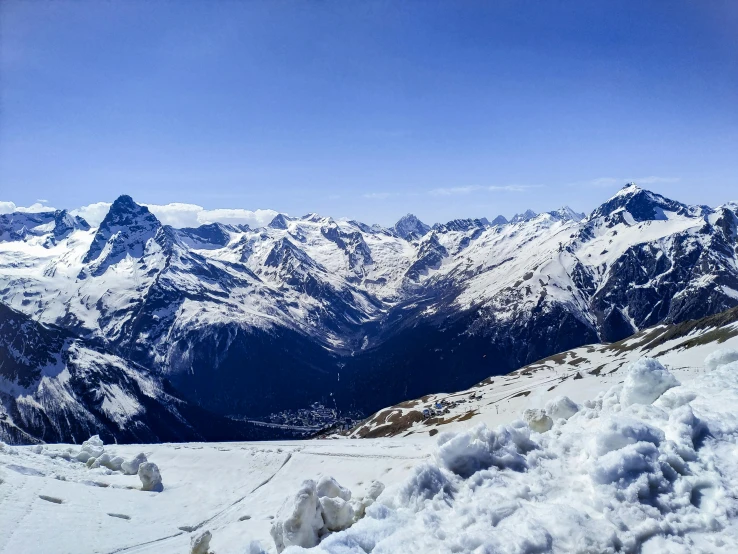 a view of mountains from a snowy area