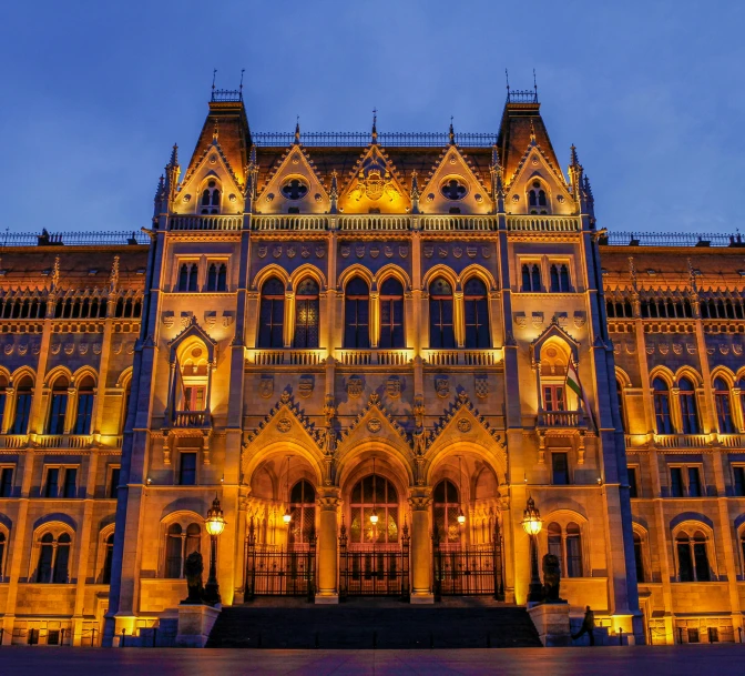 this building is illuminated up in gold and has windows