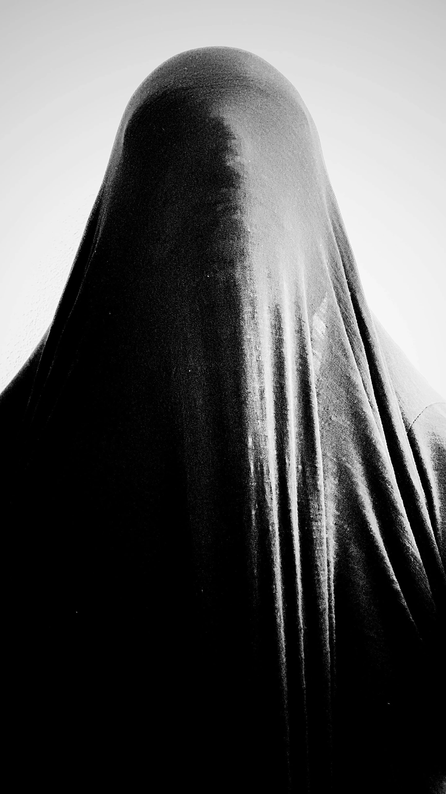 there is a woman in a black scarf covering her face