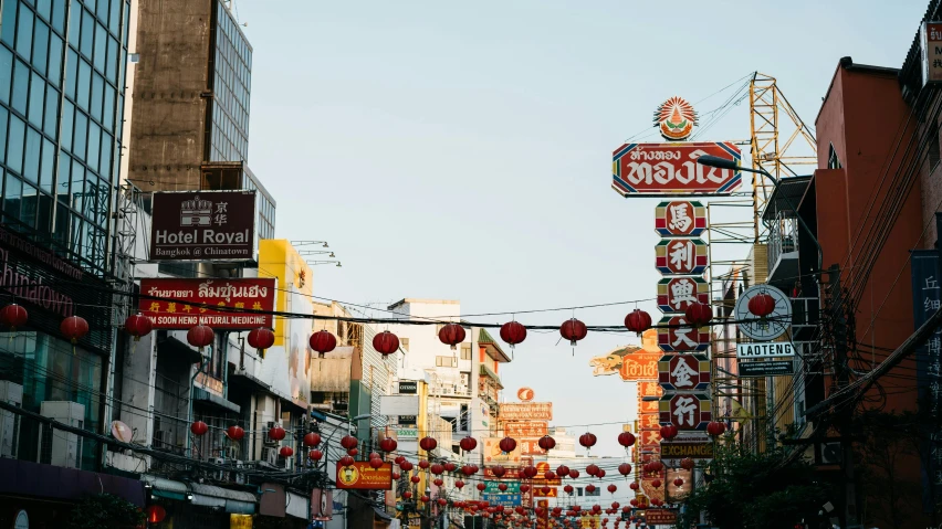 several signs hang from the wires in this asian area