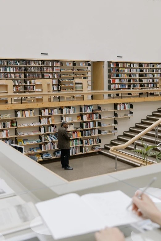 two people looking at books in a liry