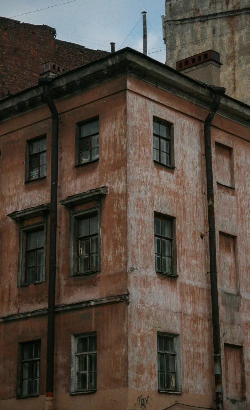 a dilapidated old building with the roof gutted