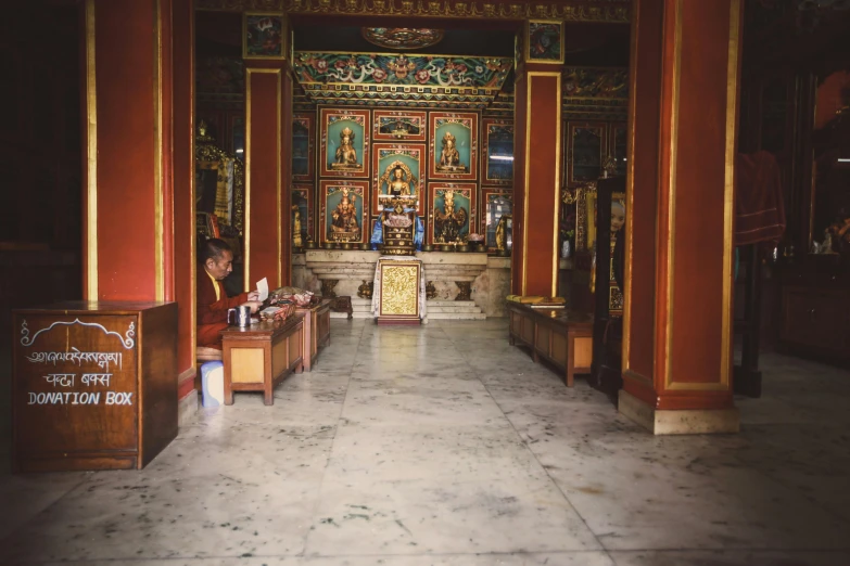 a woman walking through a hallway with many decorations