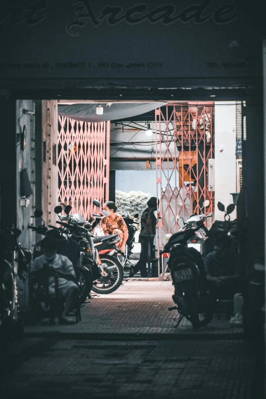 people are preparing their motorcycles outside in a garage