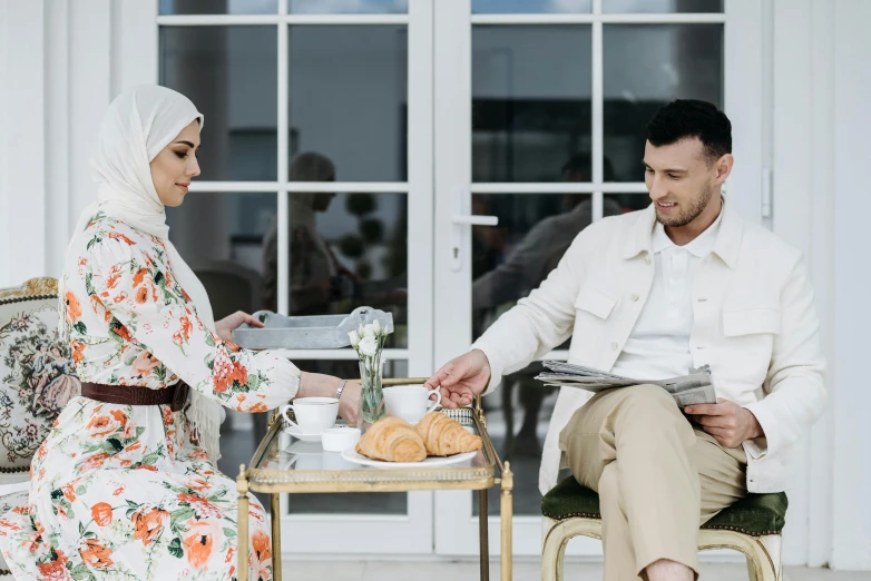 a man and woman are having a meal on a patio