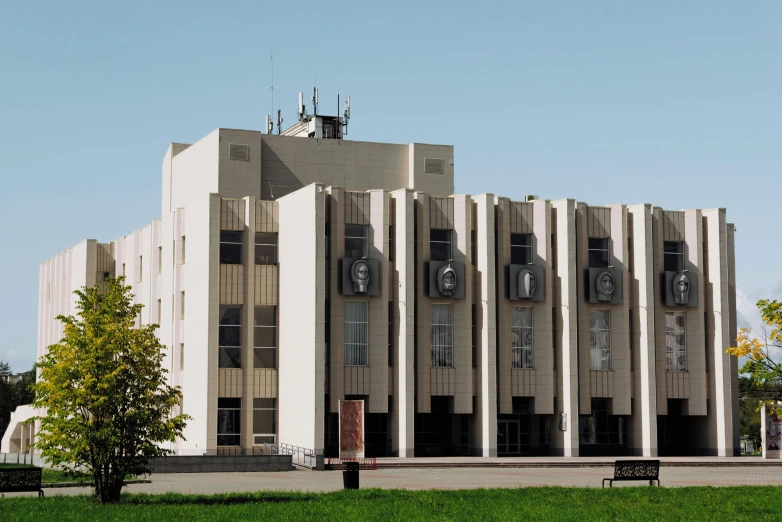 the view of an old building with trees and a clock