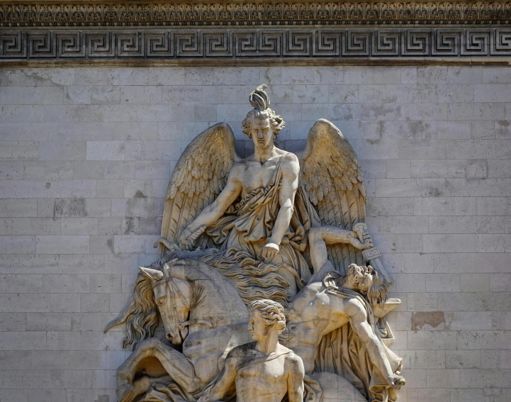 the large marble sculpture is next to a building