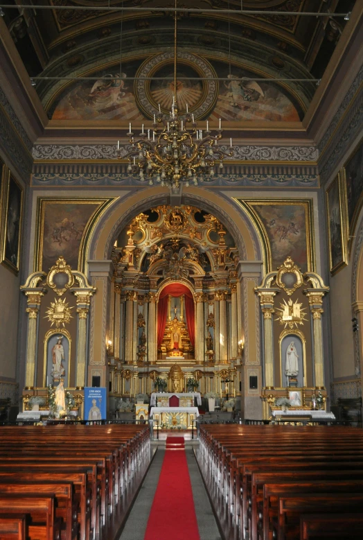 a large church with many pews and a red carpet