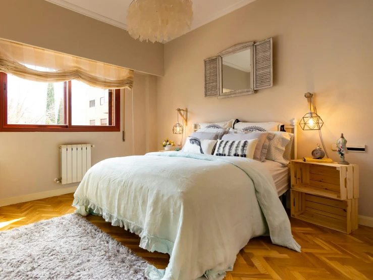 a white bed with lots of pillows and blankets