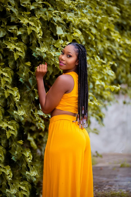 the back of a woman wearing an orange dress with long ids