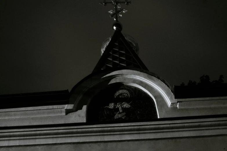 a church steeple lit up at night