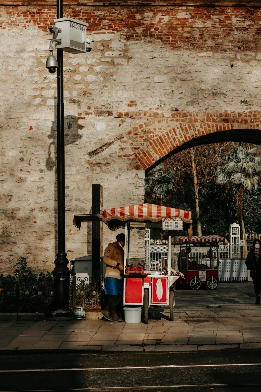 a street scene of a man at the food vendor