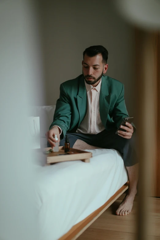 a man sitting on top of a bed playing chess