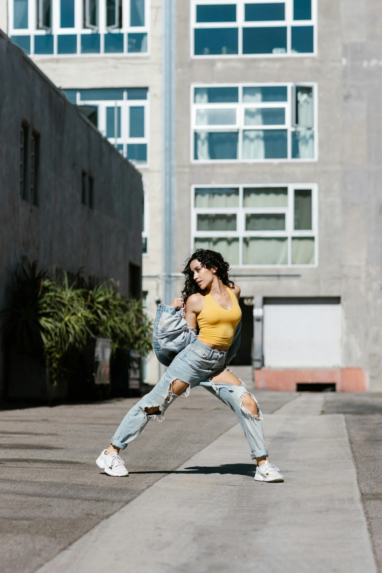 a woman is standing on one leg with her hands on the side