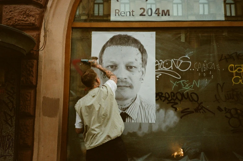 a man hanging off a building while looking through a glass window