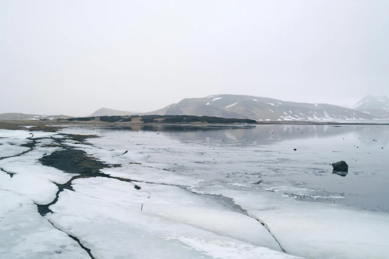 a lone boat floating in a very frozen water